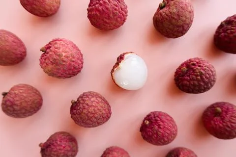 Fresh lychee fruit on pink background flat lay Stock Photos