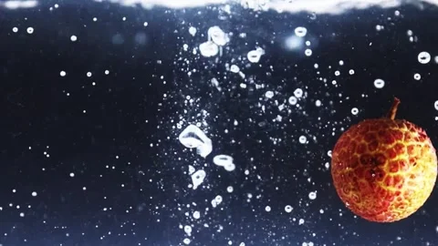 Fresh lychees falling into clear water. Stock Footage 335706376