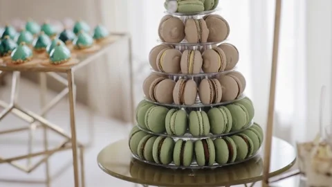 Fresh macaroon macarons baked from almond flour and smeared with cream stand in Stock Footage 234546496