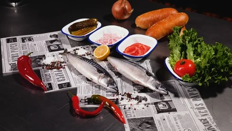 Fresh mackerel. Next to bread with onions, pickles, tomato and herbs and pepper. Stock Footage 127959928