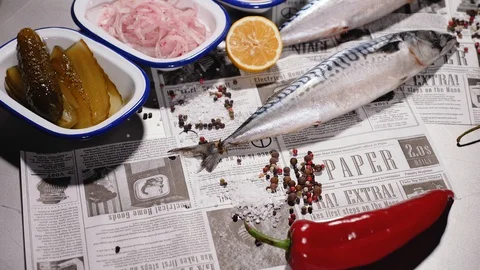 Fresh mackerel next to fresh bread, onions, pickles, tomato, herbs and pepper. Stock Footage 127960304