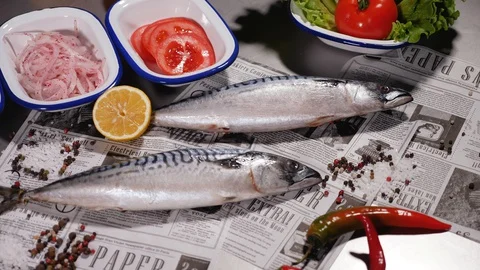 Fresh mackerel next to fresh bread, onions, pickles, tomato, herbs and pepper. Stock Footage 127960421