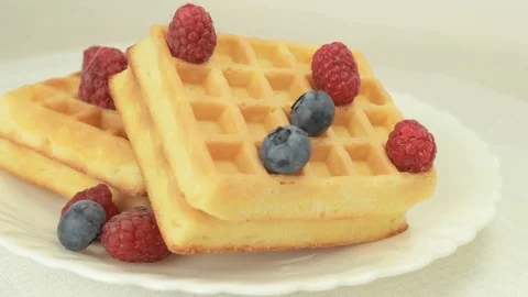 Fresh made waffles with blueberries and raspberries rotating Video stock 80647140