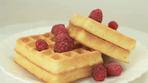 Fresh made waffles with raspberries rotating Stock Footage 80646567