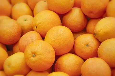 Fresh mandarin oranges texture. Fresh oranges lying on the counter - orange and Stock Photos