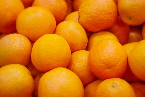 Fresh mandarin oranges texture. Fresh oranges lying on the counter - orange and Stock Photos