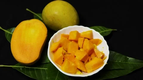 Fresh mango cubes served in white bowl with ripe tropical fruit presentation Stock Footage 337140702