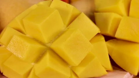 Fresh mango cubes on wooden board with pomegranate seeds and summer fruits .. Stock Footage 332723772