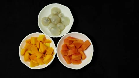 Fresh mango papaya and lychee fruit platter showcasing vibrant natural colors Stock Footage 337455516