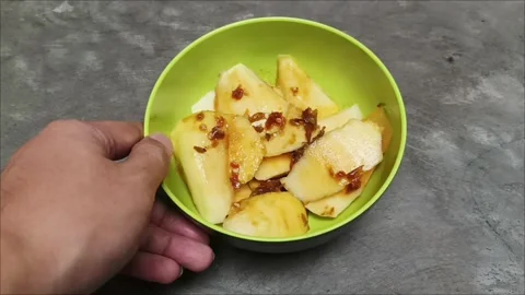 Fresh mango sliced thinly with sweet, sour, and spicy palm sugar sauce Stock Footage 323579497
