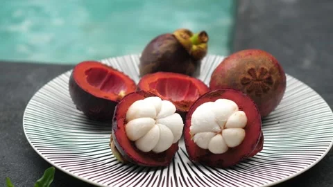 Fresh mangosteens at the poolside Stock Footage 252338217