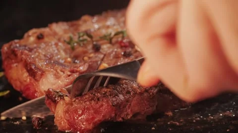 Fresh marbled beef with pepper, salt and rosemary close-up macro. Cutting with Stock Footage 262577824