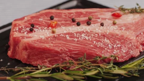 Fresh marbled beef with pepper, salt and rosemary close-up macro. Preparation to Stock Footage 262577892