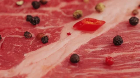 Fresh marbled beef with pepper, salt and rosemary close-up macro. Preparation to Stock Footage 262577965