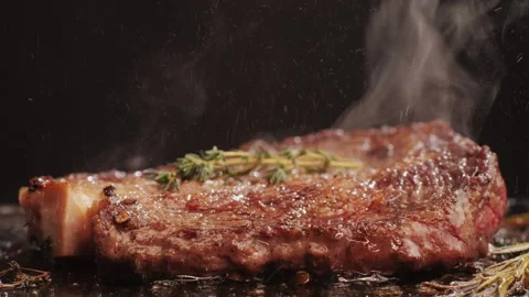 Fresh marbled beef with pepper, salt and rosemary close-up macro. Cooking juicy Stock Footage 262578384