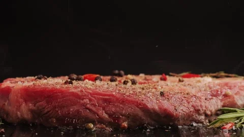 Fresh marbled beef with pepper, salt and rosemary close-up macro. Cooking juicy Stock Footage 263085424