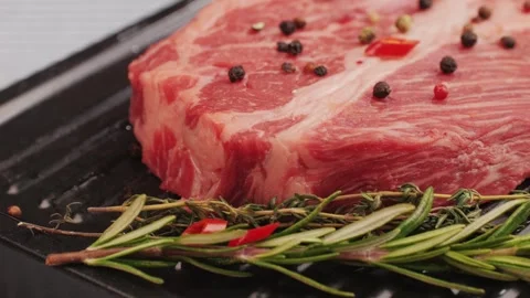Fresh marbled beef with pepper, salt and rosemary close-up macro. Preparation to Stock Footage 263086909