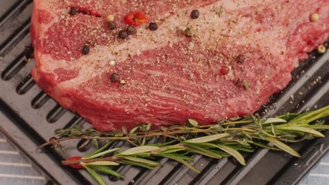 Fresh marbled beef with pepper, salt and rosemary close-up macro. Preparation to Stock Footage 264423624