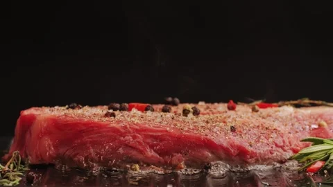 Fresh marbled beef with pepper, salt and rosemary close-up macro. Cooking juicy Stock Footage 265164111