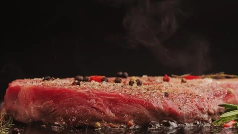 Fresh marbled beef with pepper, salt and rosemary close-up macro. Cooking juicy Stock Footage 266960275