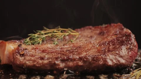 Fresh marbled beef with pepper, salt and rosemary close-up macro. Cooking juicy Stock Footage 266960400