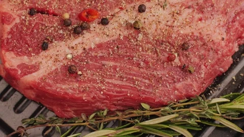 Fresh marbled beef with pepper, salt and rosemary close-up macro. Preparation to Stock Footage 266960488