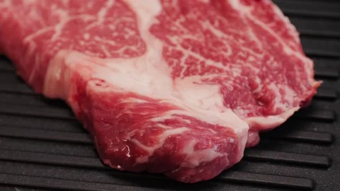 Fresh marbled beef with pepper, salt and rosemary close-up macro. Preparation to Stock Footage 271661176