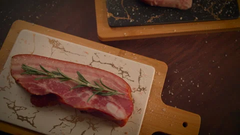 Fresh Meat arranged on a Serving Board with aromatic Herbs for exquisite Stock Footage 293372229