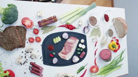 Fresh meat on cutting board surrounded by seasonings Stock Footage 233098419