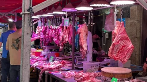 Fresh Meat Hangs at a Butcher Stall in Rainy Dandong Market Stock Footage 340175967