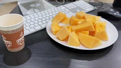 Fresh Melon Cubes And Coffee Cup On Desk Stock Footage 337703799