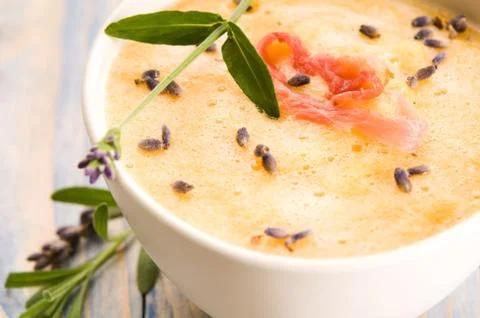 Fresh melon soup with parma ham and lavender flower Stock Photos