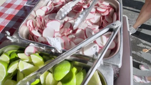 Fresh Mexican Taco Condiments | Lime, Pickled Red Onions, and Radishes Close-Up Stock Footage 338299346