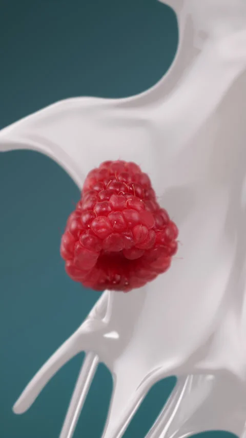 Fresh milk splash falling in slow motion with raspberry Stock Footage 255678758