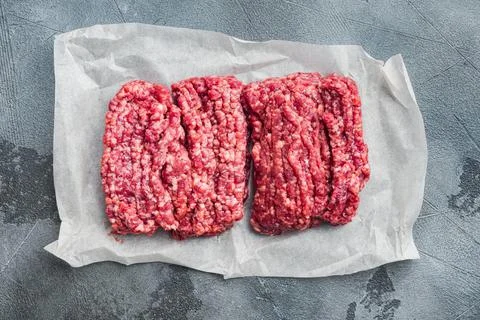 Fresh minced meat ground beef, on gray background, top view flat lay Stock Photos