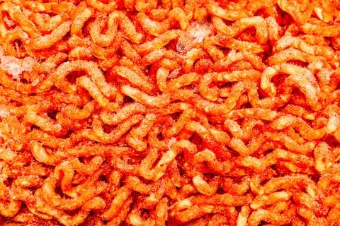 Fresh minced meat in packaging, close-up shot. Stock Photos