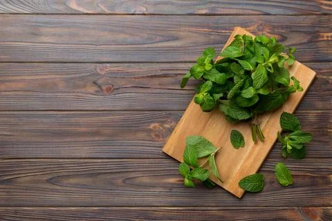 Fresh mint on Cutting board table, top view. Flat lay Space for text Stock Photos