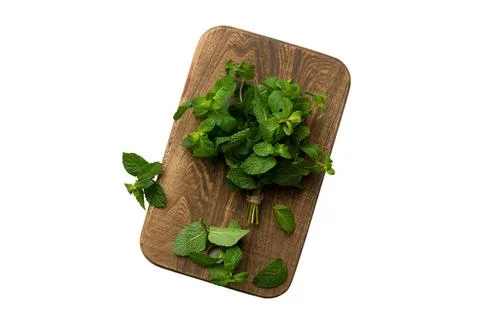 Fresh mint on Cutting board table isolated on white background, top view. F.. Stock Photos