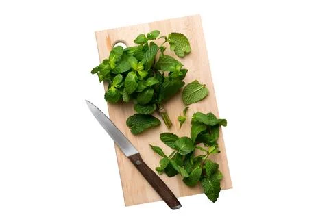 Fresh mint on Cutting board table isolated on white background, top view. Fla Stock Photos