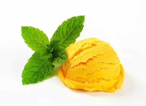 Fresh mint leaf with scoop of yellow ice cream Stock Photos