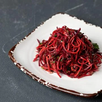 Fresh mixed red salad with beetroot, carrot and herbs on clay dish. Natural Stock Photos