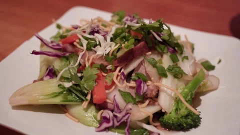 Fresh mixed vegetable salad served on a white plate 库存影片 326208267