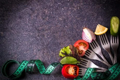 Fresh mixed vegetables on fork on black background Stock Photos