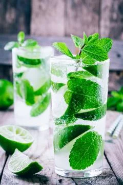 Fresh mojito cocktails with lime, mint and ice in glass Stock Photos