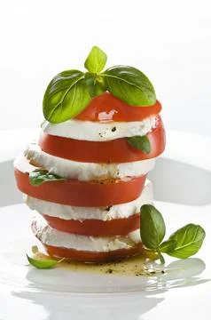 Fresh mozzarella, tomato and basil salad close up Stock Photos