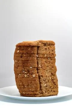 Fresh multi grain bread in a ceramic plate on white background Stock Photos