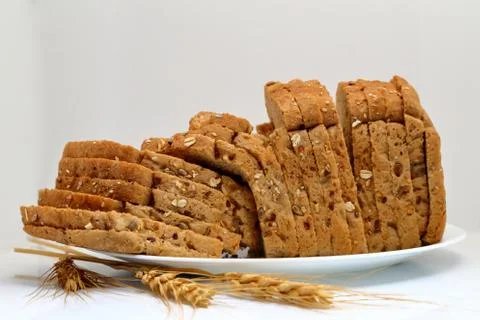 Fresh multi grain bread in a ceramic plate on white background Stock Photos