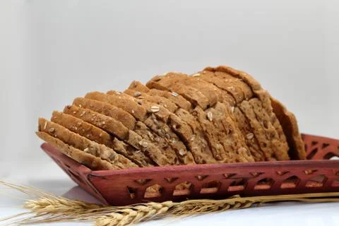 Fresh multi grain bread in a ceramic plate on white background Stock Photos