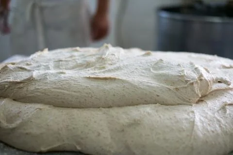 Fresh Multigrained Bread Dough with Blurry Baker Stock-Fotos