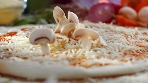 Fresh mushroom slices falling onto raw pizza dough with tomato sauce and mo.. Stock Footage 337384859